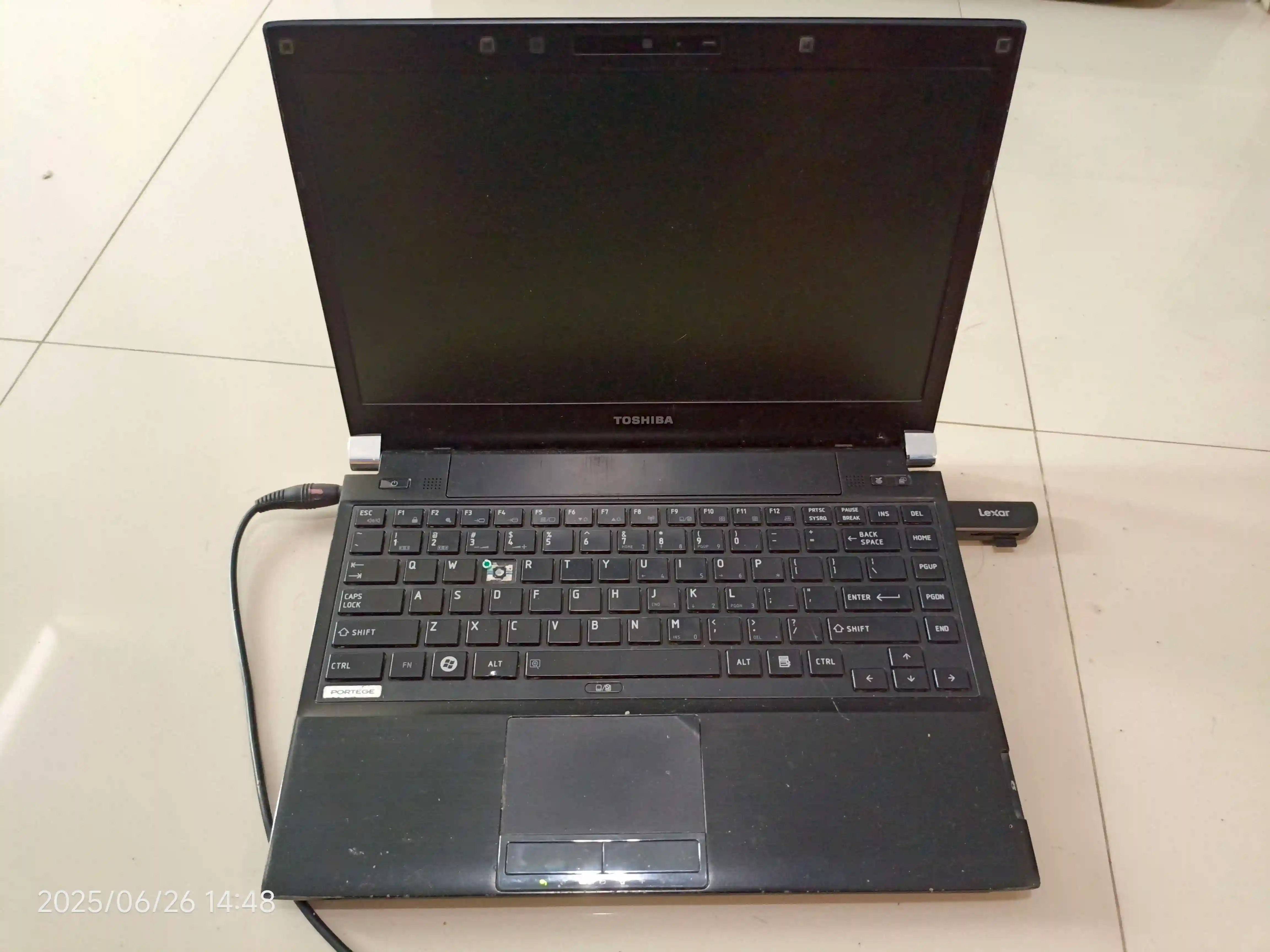 The Toshiba PORTEGE R700 revealing its front side with the lid open and screen off